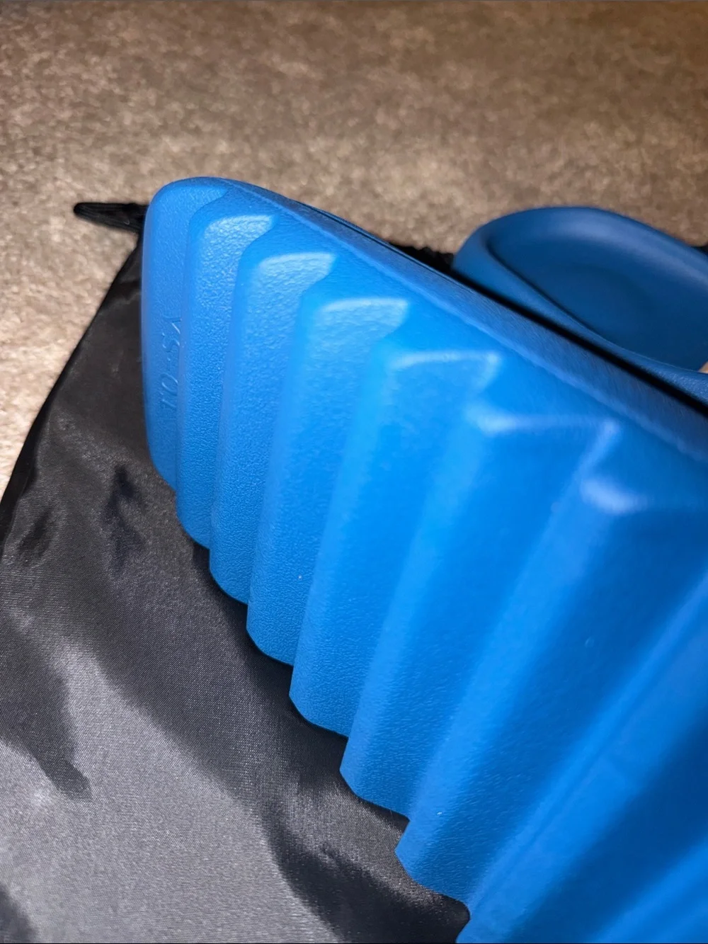 foam runner/slides inspired by Yeezy‎ designs. The bag says “YS-01,”